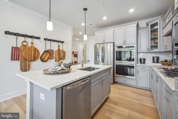 a kitchen with a sink stove and refrigerator