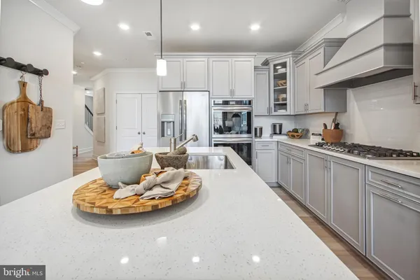 a kitchen with a sink a stove and chairs