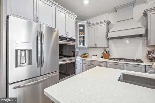 a kitchen with stainless steel appliances a refrigerator sink and microwave