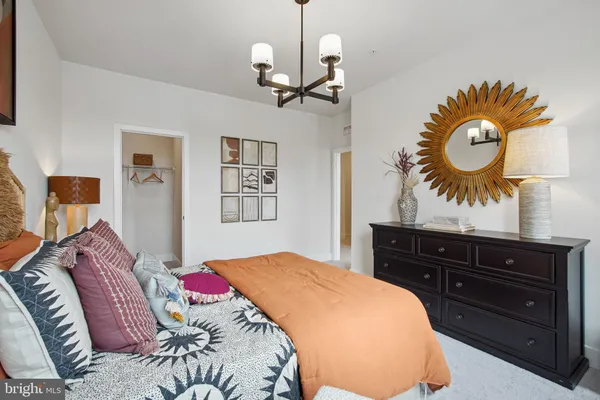 a bedroom with a bed and a chandelier