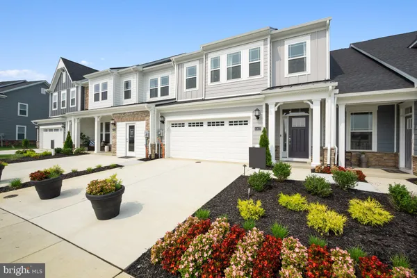 a view of a brick house with potted plants