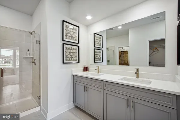 a bathroom with double sink and a mirror
