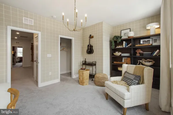 a living room with furniture and a chandelier
