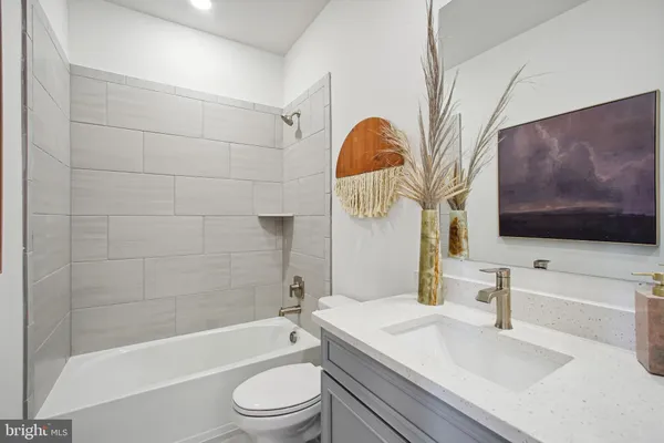 a bathroom with a sink a toilet and bathtub