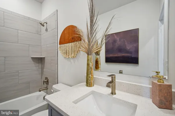 a bathroom with a sink a mirror and vanity