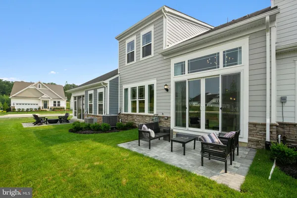 a view of a house with a backyard and sitting area