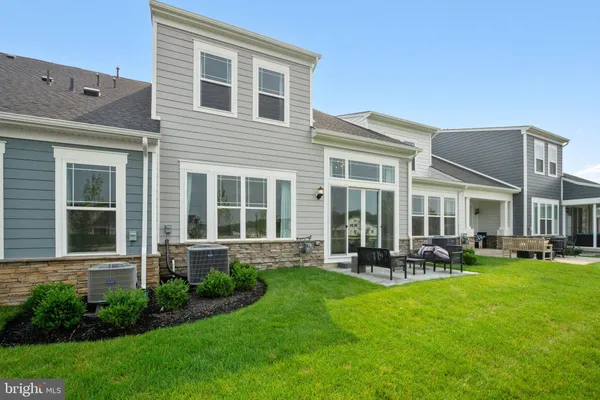 a front view of a house with a yard and sitting area