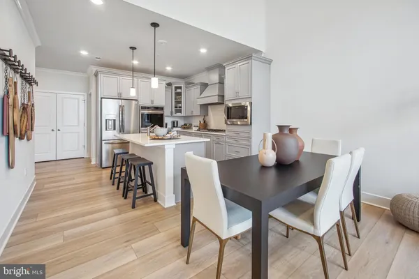 a dining room with furniture and wooden floor
