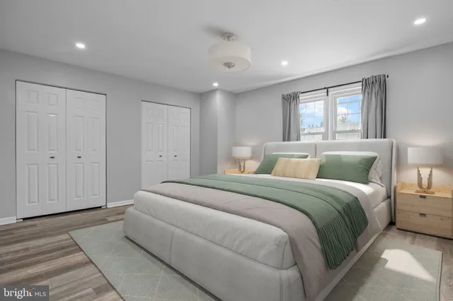 a spacious bedroom with a bed and a window