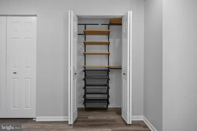 a view of walk in closet with empty racks