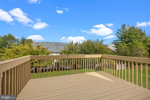a view of balcony with wooden floor and fence