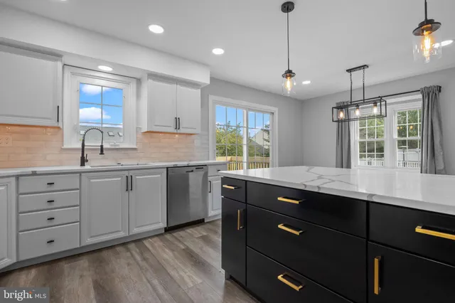 a kitchen with a sink window and cabinets