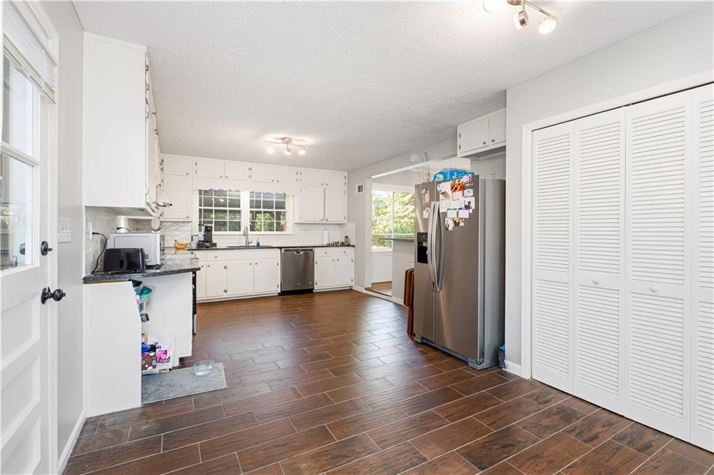 531 Crestview Terrace Gainesville, GA 30501 - Photo 12 of 54 a kitchen with stainless steel appliances kitchen island granite countertop a refrigerator and a stove top oven