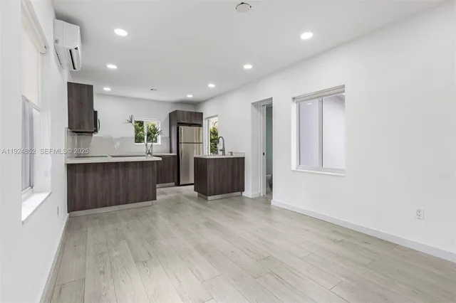 a view of kitchen and kitchen with wooden floor