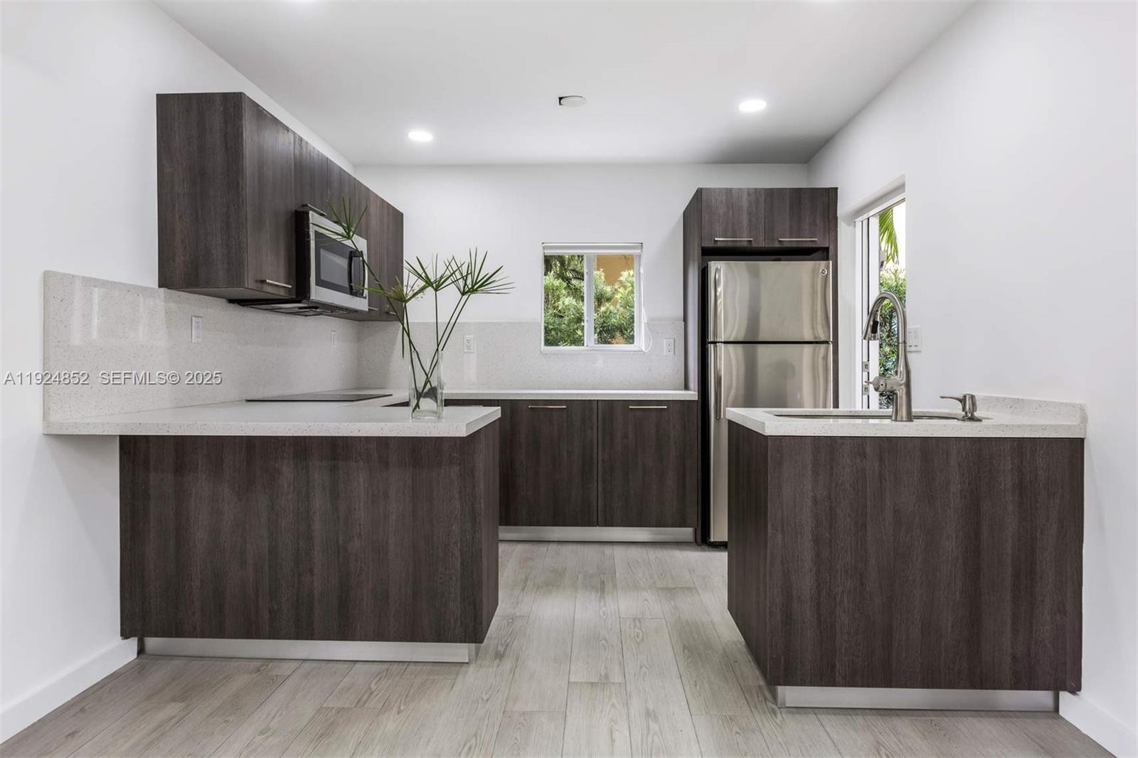 623 Northeast 61st Street, Unit 5 Miami, FL 33137 - Photo 5 of 12 a kitchen with stainless steel appliances a refrigerator and a microwave