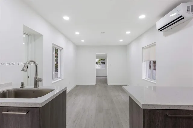 a kitchen with sink and cabinets