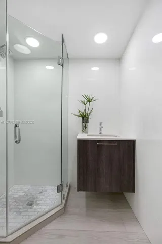 a bathroom with a shower and a sink