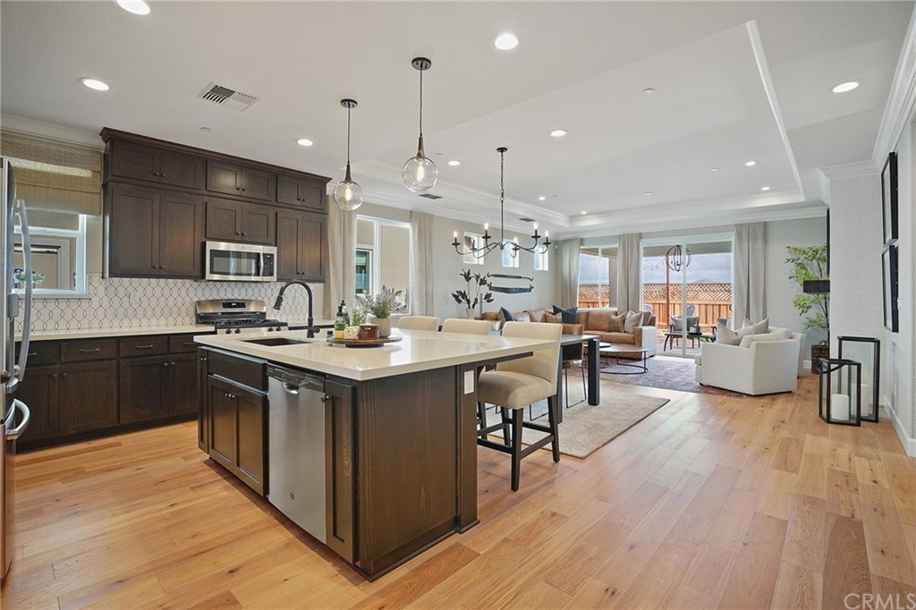 3445 Chamberlain Run Chico, CA 95973 - Photo 6 of 17 a kitchen with stainless steel appliances kitchen island granite countertop a sink and cabinets