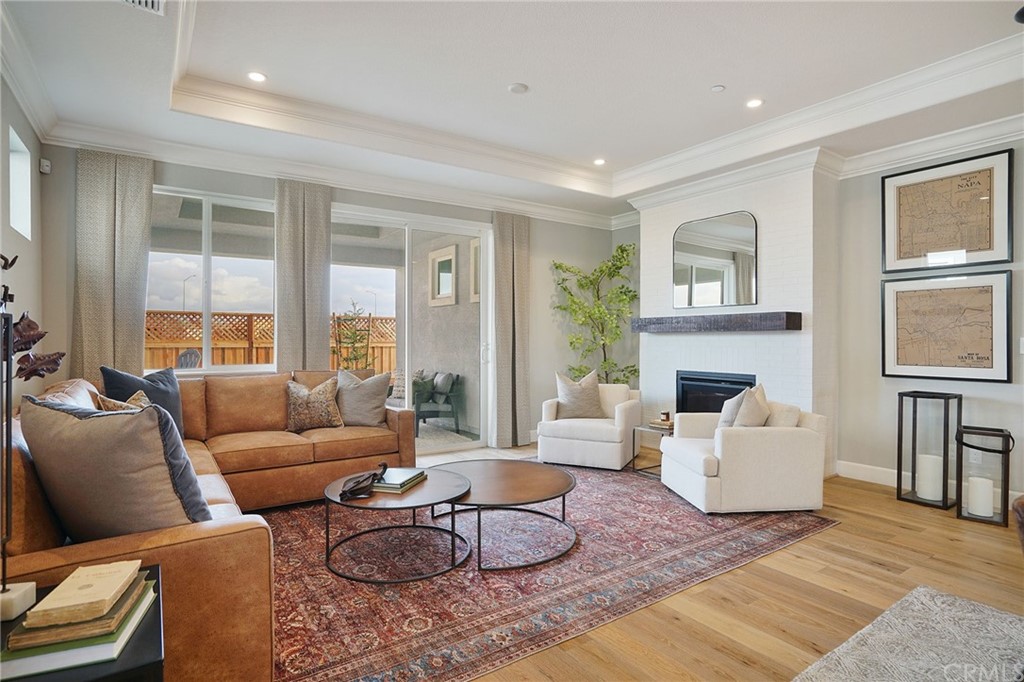 3445 Chamberlain Run Chico, CA 95973 - Photo 8 of 17 a living room with furniture a large window and a fireplace