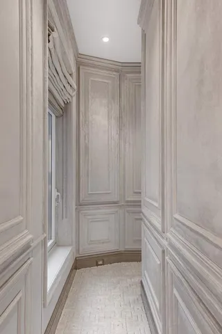 a kitchen with stainless steel appliances granite countertop a stove a refrigerator a microwave oven with a dining table and chairs with wooden floor