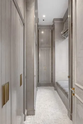 a view of an empty room with cabinet and closet