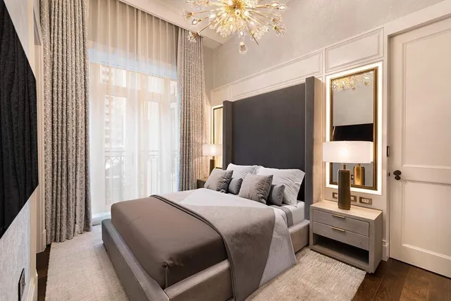 a living room with furniture and a chandelier