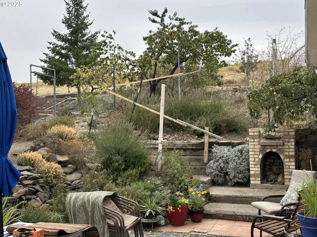 a view of backyard with seating area and green space