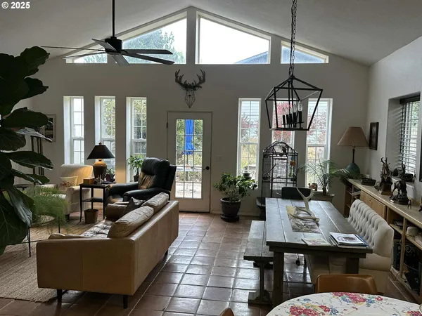 a living room with furniture a chandelier and a flat screen tv