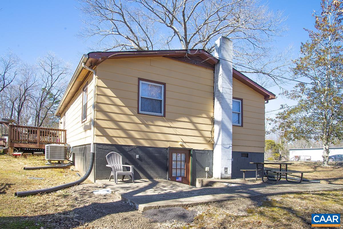 838 Matthew Mill Road Ruckersville, VA 22968 - Photo 11 of 12 a backyard of a house with outdoor seating