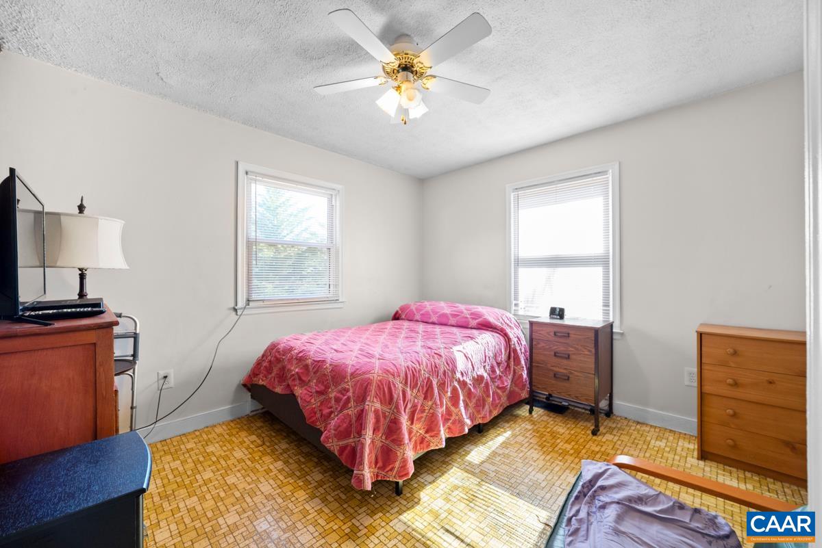 838 Matthew Mill Road Ruckersville, VA 22968 - Photo 6 of 12 a bedroom with a bed and a chandelier