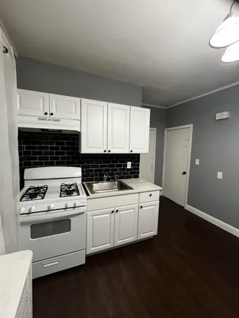 a kitchen with a stove a sink and a microwave