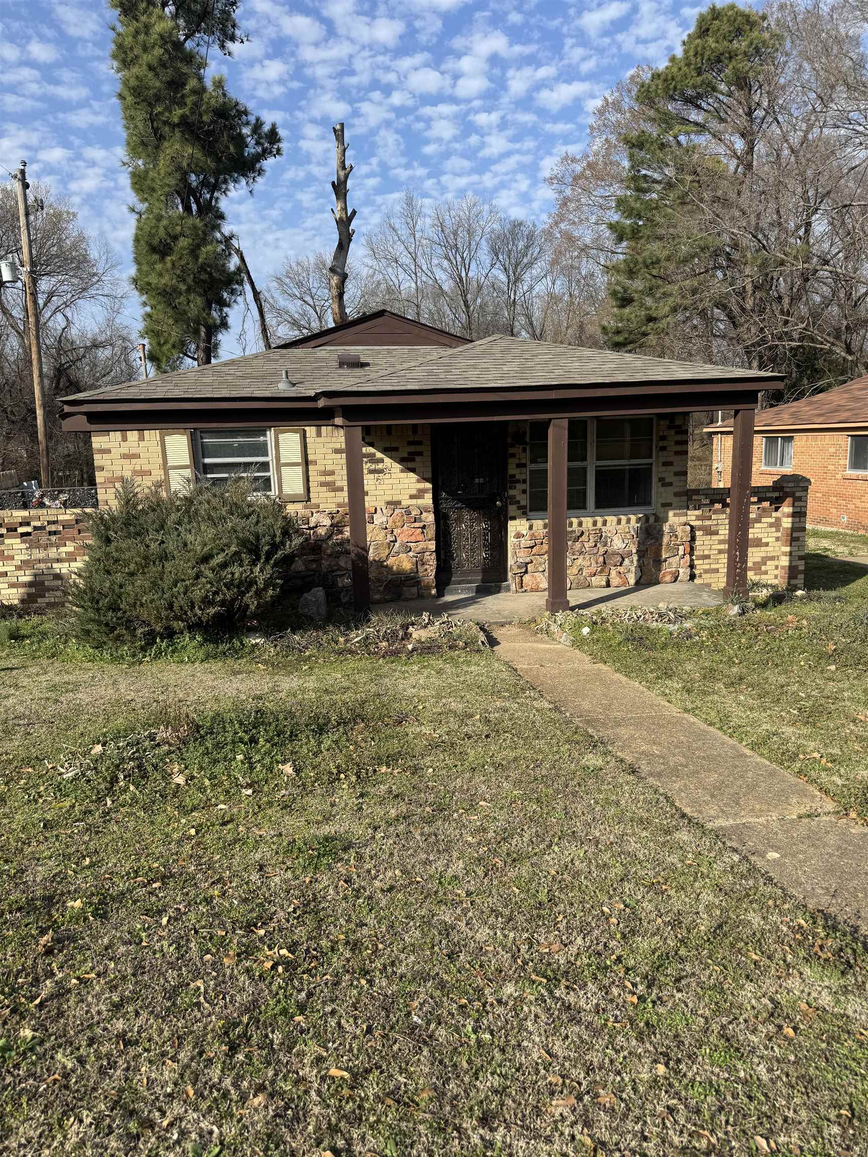 676 Nonconnah Road Memphis, TN 38109 - Photo 1 of 20 View of front of house featuring a front yard, covered porch, and brick siding