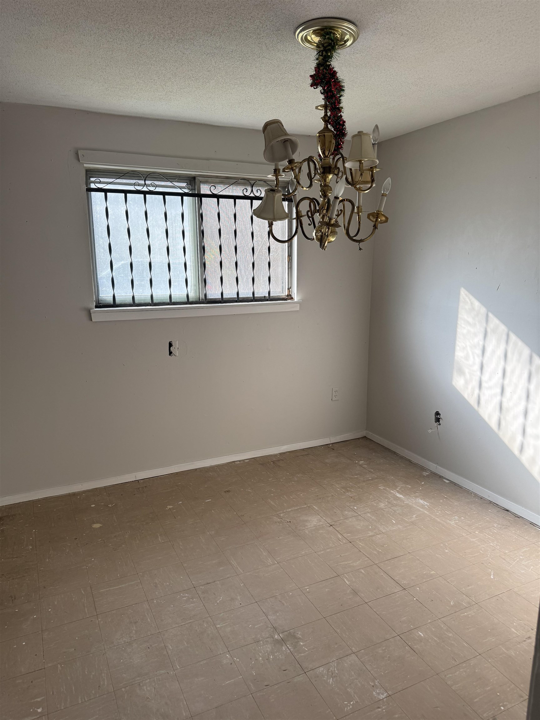 676 Nonconnah Road Memphis, TN 38109 - Photo 13 of 20 Empty room featuring a chandelier and a textured ceiling