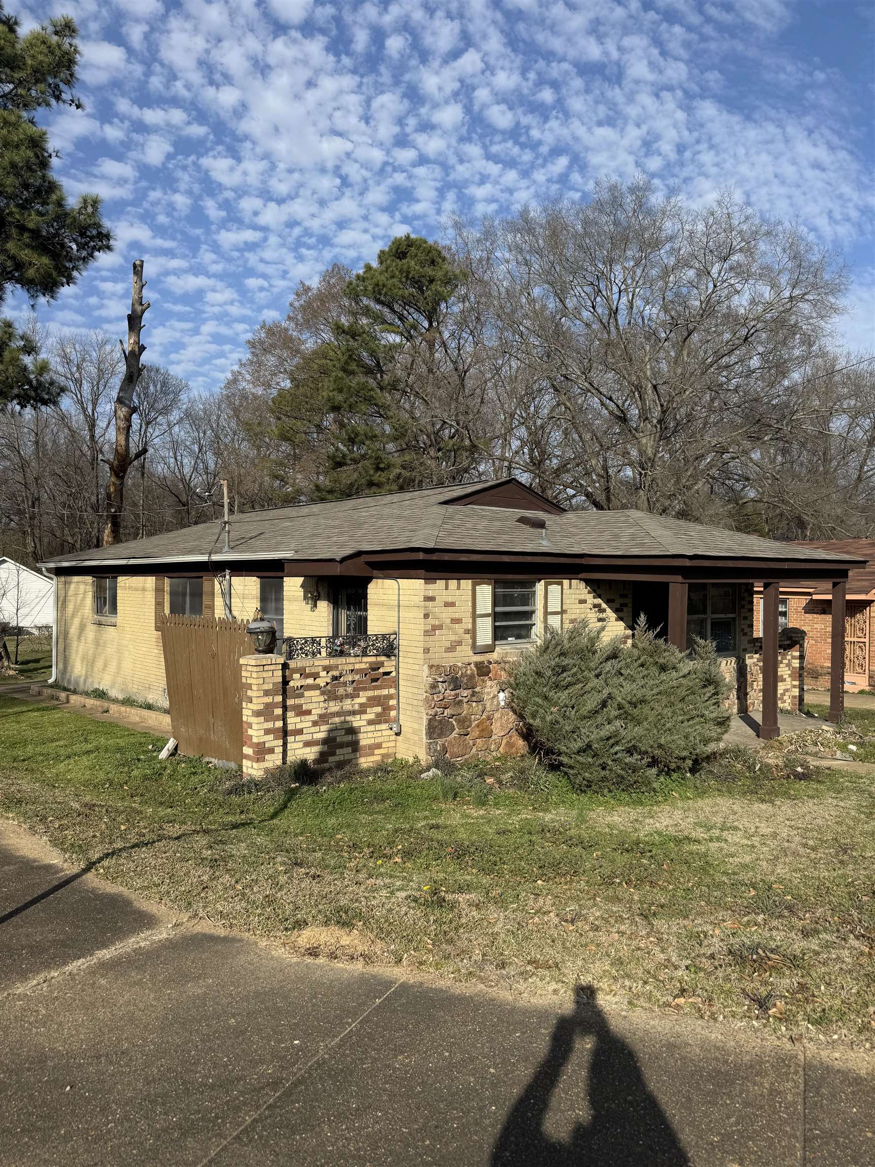 676 Nonconnah Road Memphis, TN 38109 - Photo 2 of 20 View of front of home with brick siding, a front yard, and a shingled roof