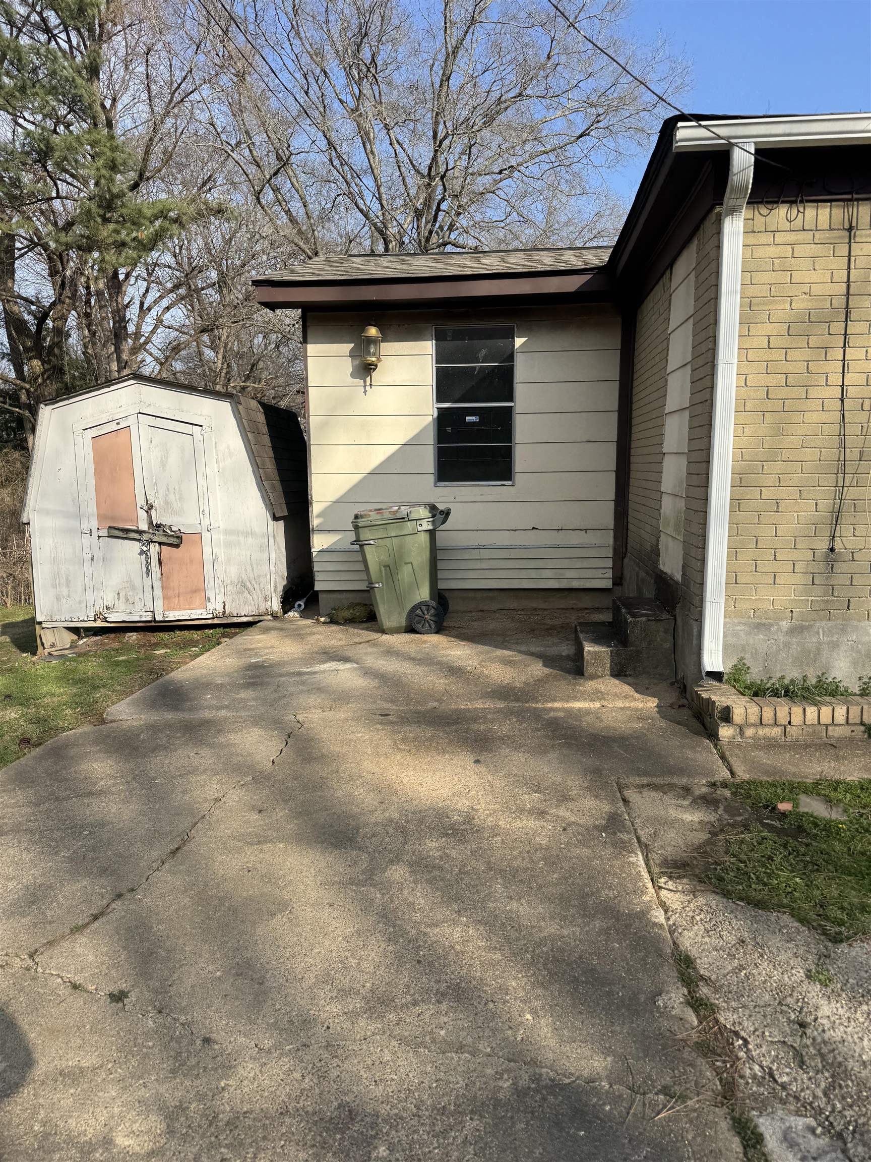 676 Nonconnah Road Memphis, TN 38109 - Photo 5 of 20 View of property exterior featuring a shed and brick siding