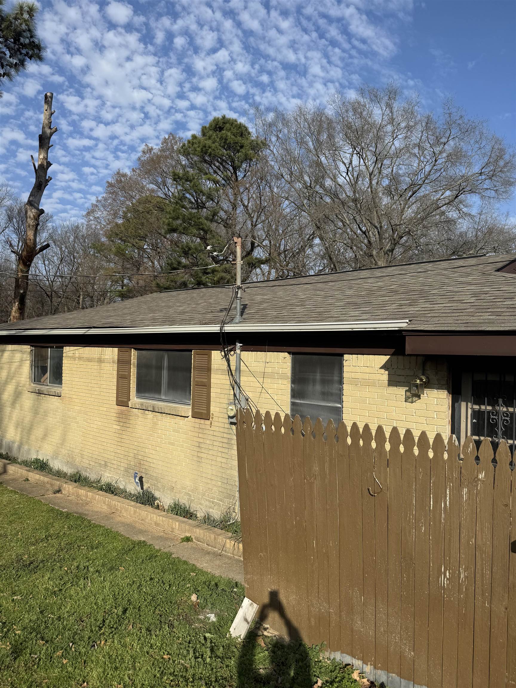 676 Nonconnah Road Memphis, TN 38109 - Photo 6 of 20 View of side of home featuring brick siding and roof with shingles