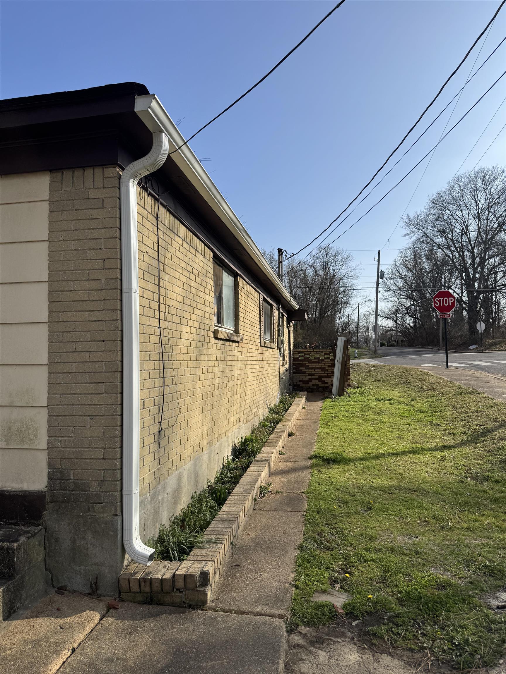 676 Nonconnah Road Memphis, TN 38109 - Photo 8 of 20 View of home's exterior featuring brick siding and a lawn