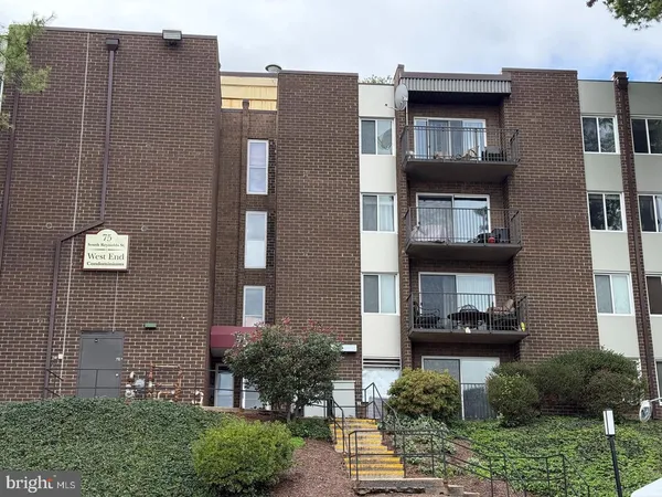 a front view of a building with garden