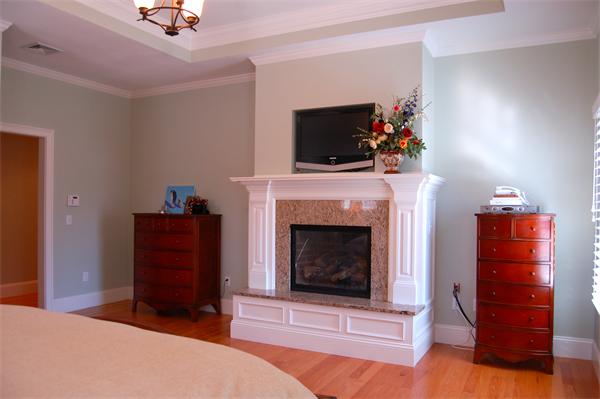 27 Oxford Road Wellesley, MA 02481 - Photo 16 of 19 a living room with a fireplace and a television