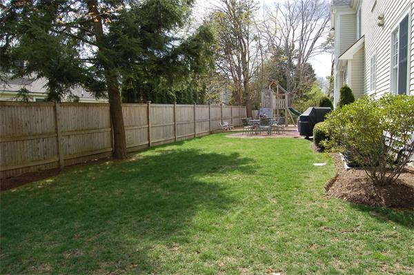 27 Oxford Road Wellesley, MA 02481 - Photo 19 of 19 a view of backyard with table and chairs and wooden fence