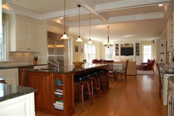27 Oxford Road Wellesley, MA 02481 - Photo 3 of 19 a kitchen with granite countertop a stove a sink a dining table and chairs with wooden floor