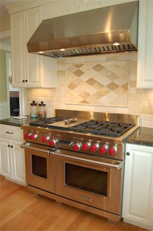 27 Oxford Road Wellesley, MA 02481 - Photo 5 of 19 a stove top oven sitting inside of a kitchen