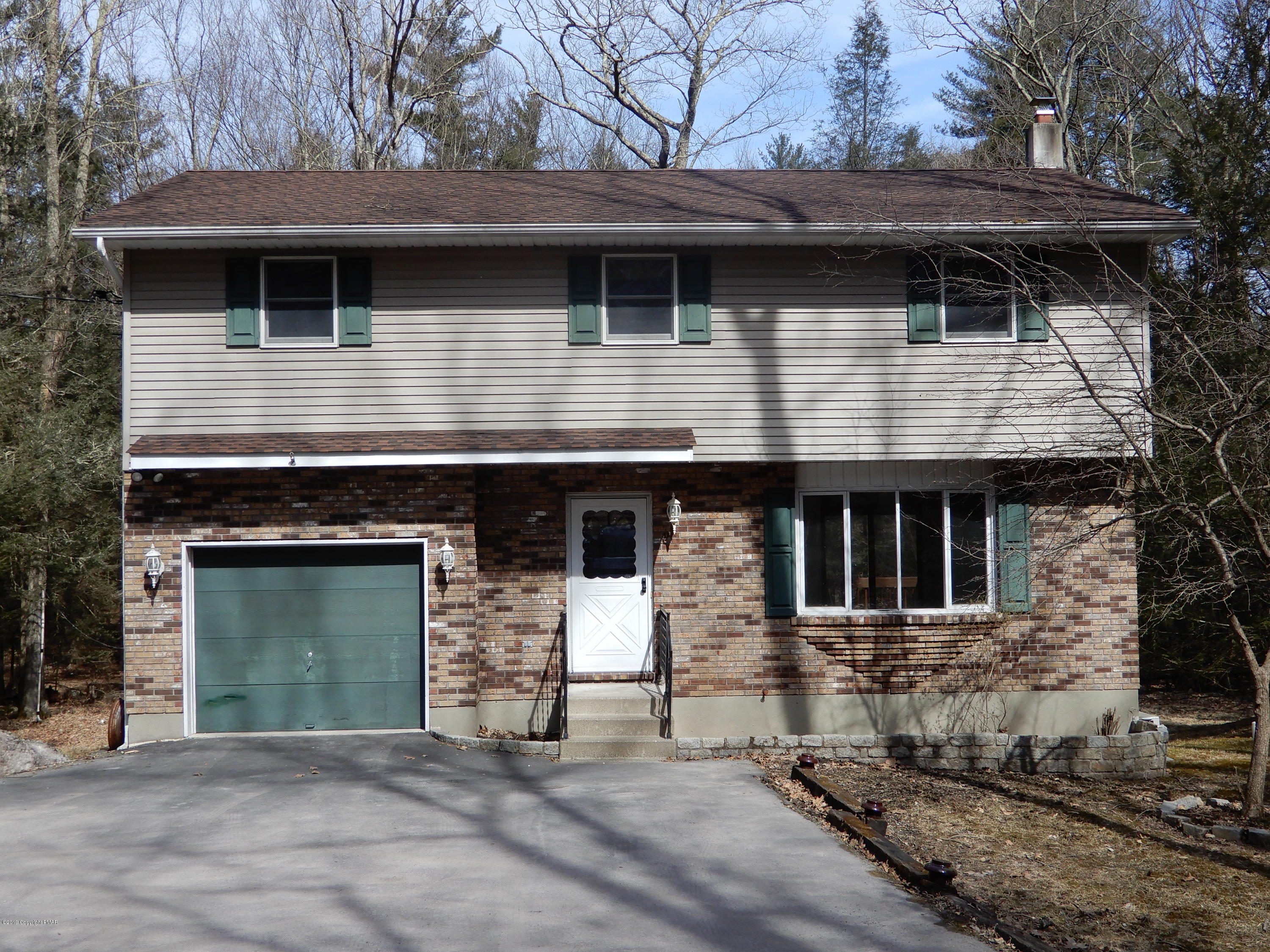 1712 Vineyard Road Stroudsburg, PA 18360 - Photo 1 of 38 a front view of a house with a garden