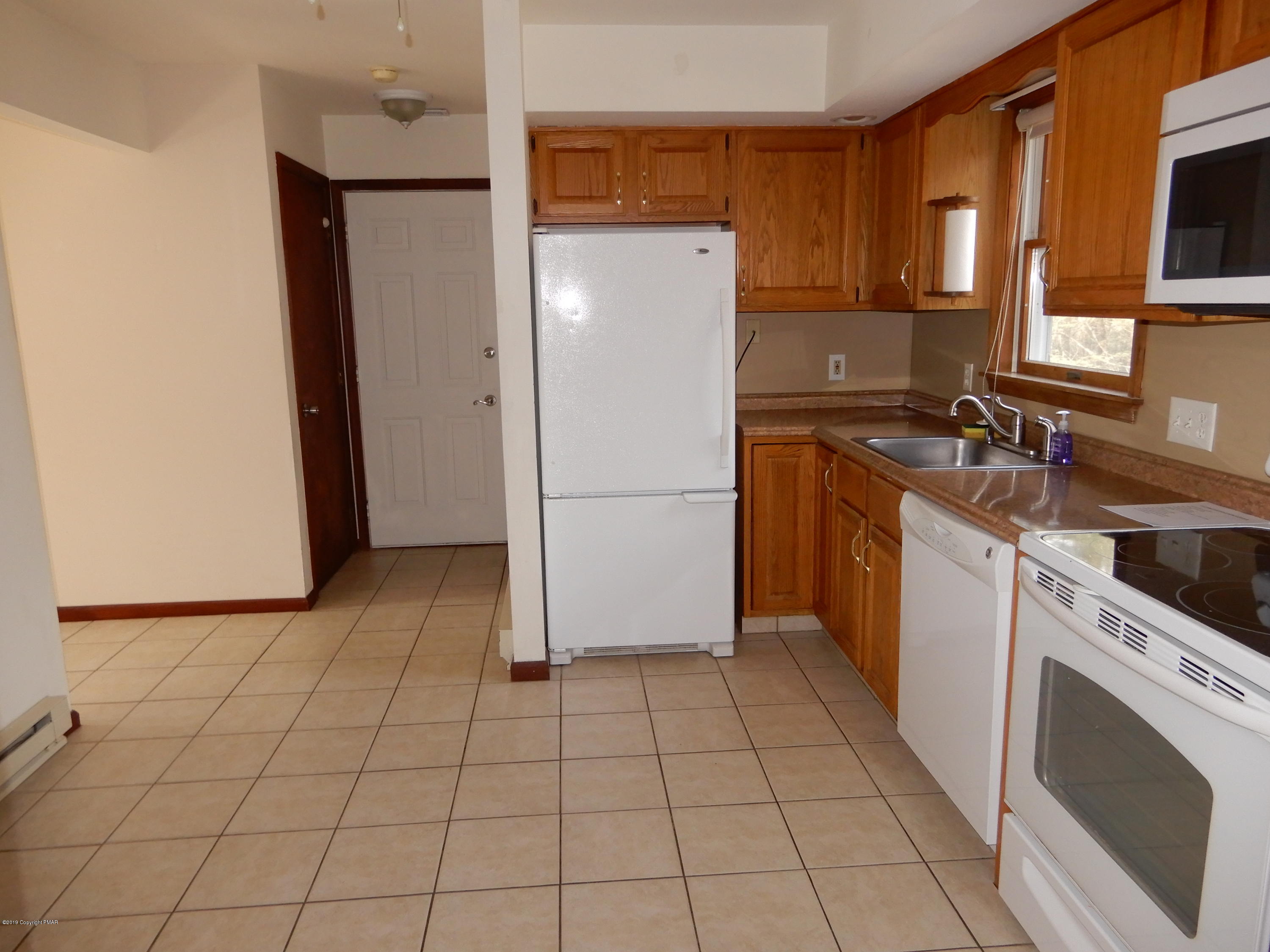 1712 Vineyard Road Stroudsburg, PA 18360 - Photo 11 of 38 a kitchen with a refrigerator sink stove and cabinets