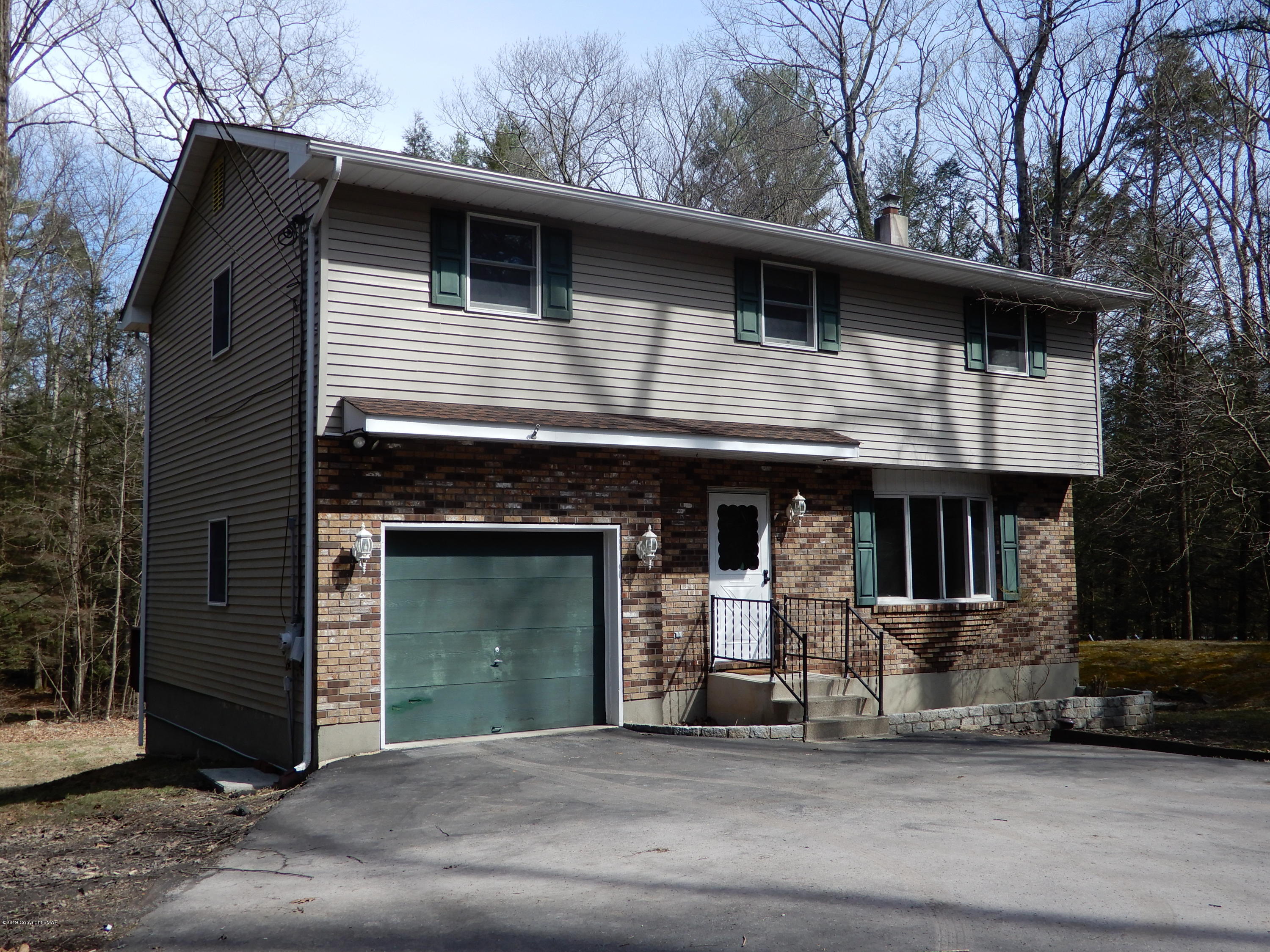 1712 Vineyard Road Stroudsburg, PA 18360 - Photo 2 of 38 a front view of a house with garage