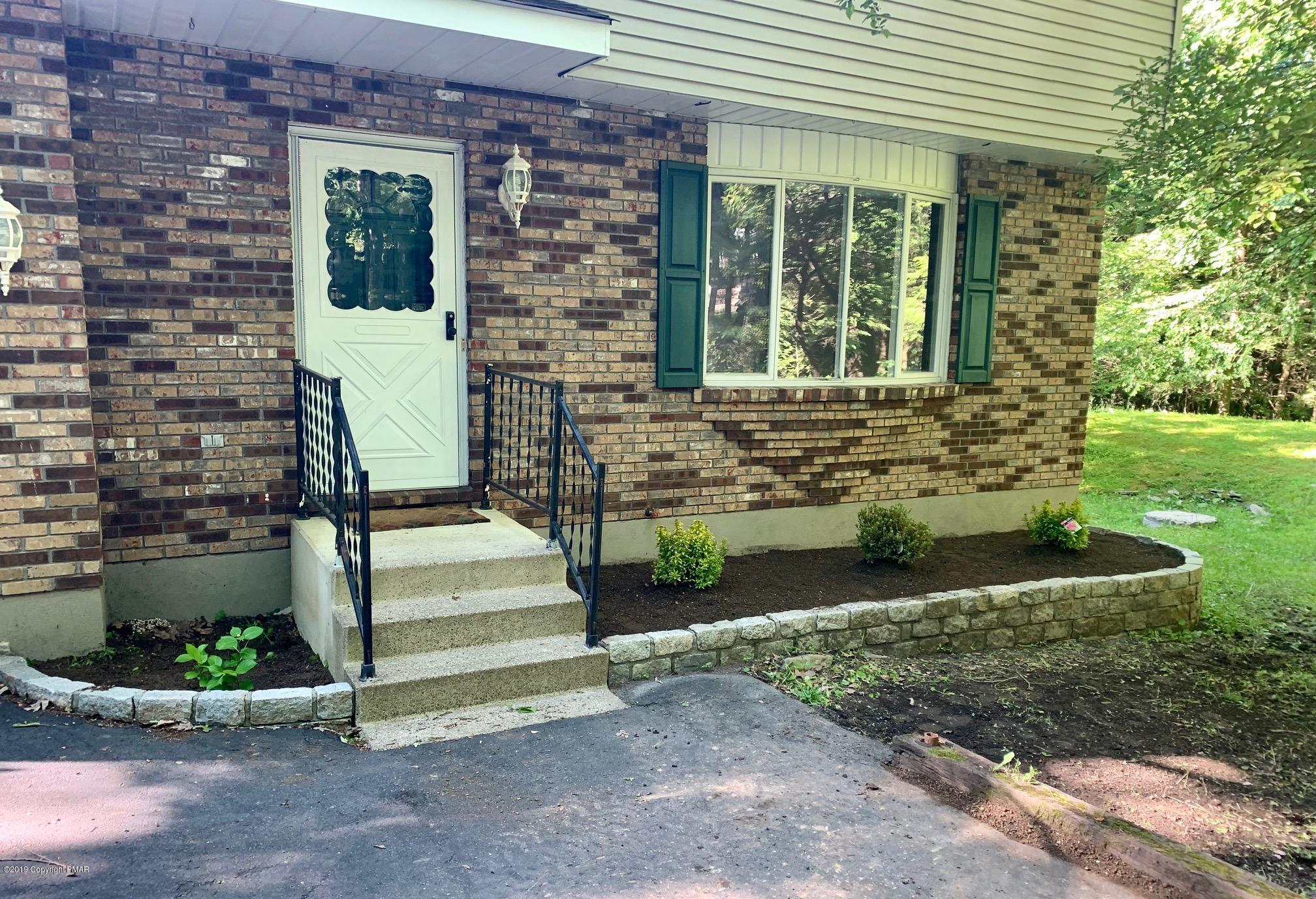 1712 Vineyard Road Stroudsburg, PA 18360 - Photo 3 of 38 a front view of a house with a yard
