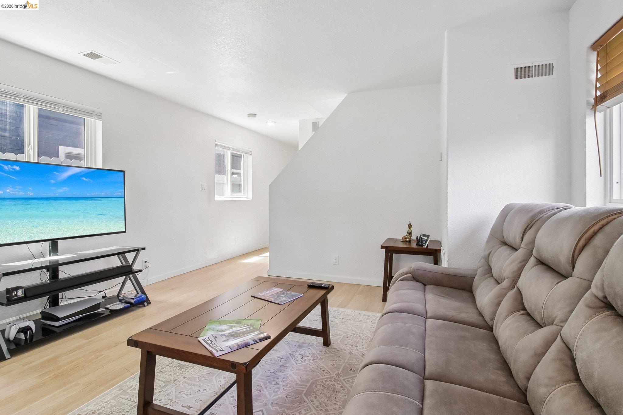 874 Pine Street Oakland, CA 94607 - Photo 7 of 39 Bright living area featuring light wood-finish flooring and white walls