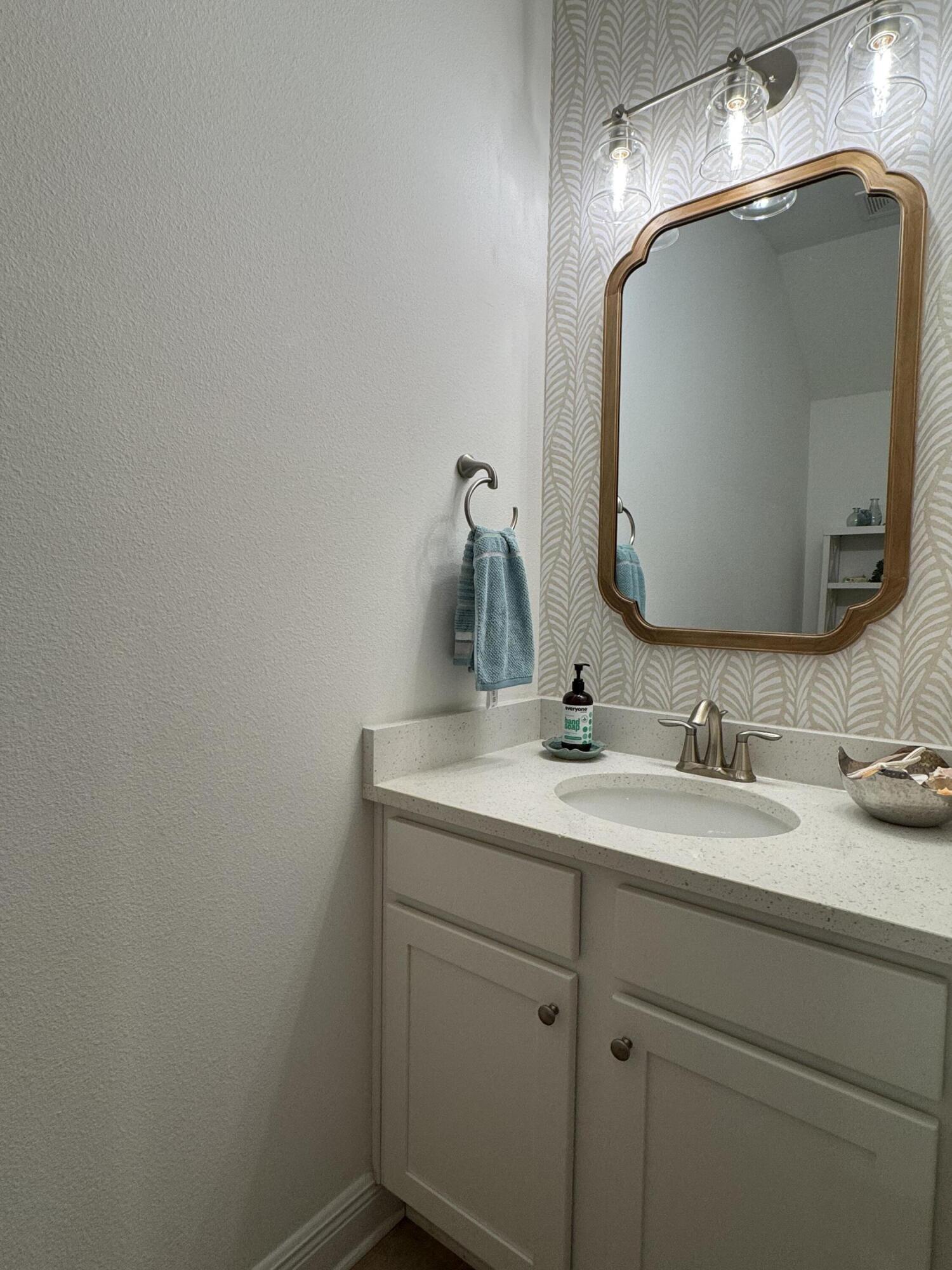40 Redbird Loop Destin, FL 32541 - Photo 3 of 14 a bathroom with a sink and a mirror