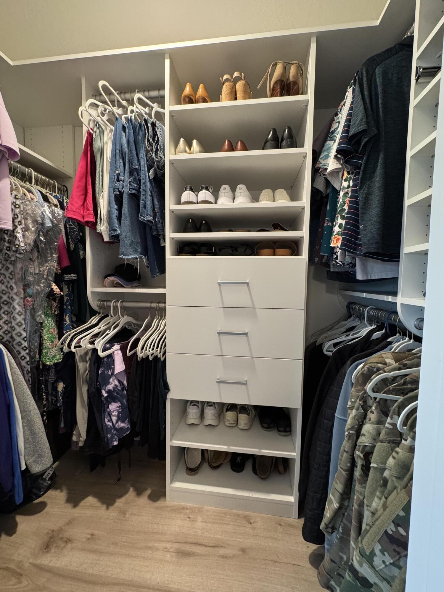 40 Redbird Loop Destin, FL 32541 - Photo 7 of 14 a view of walk in closet with clothes and shoes