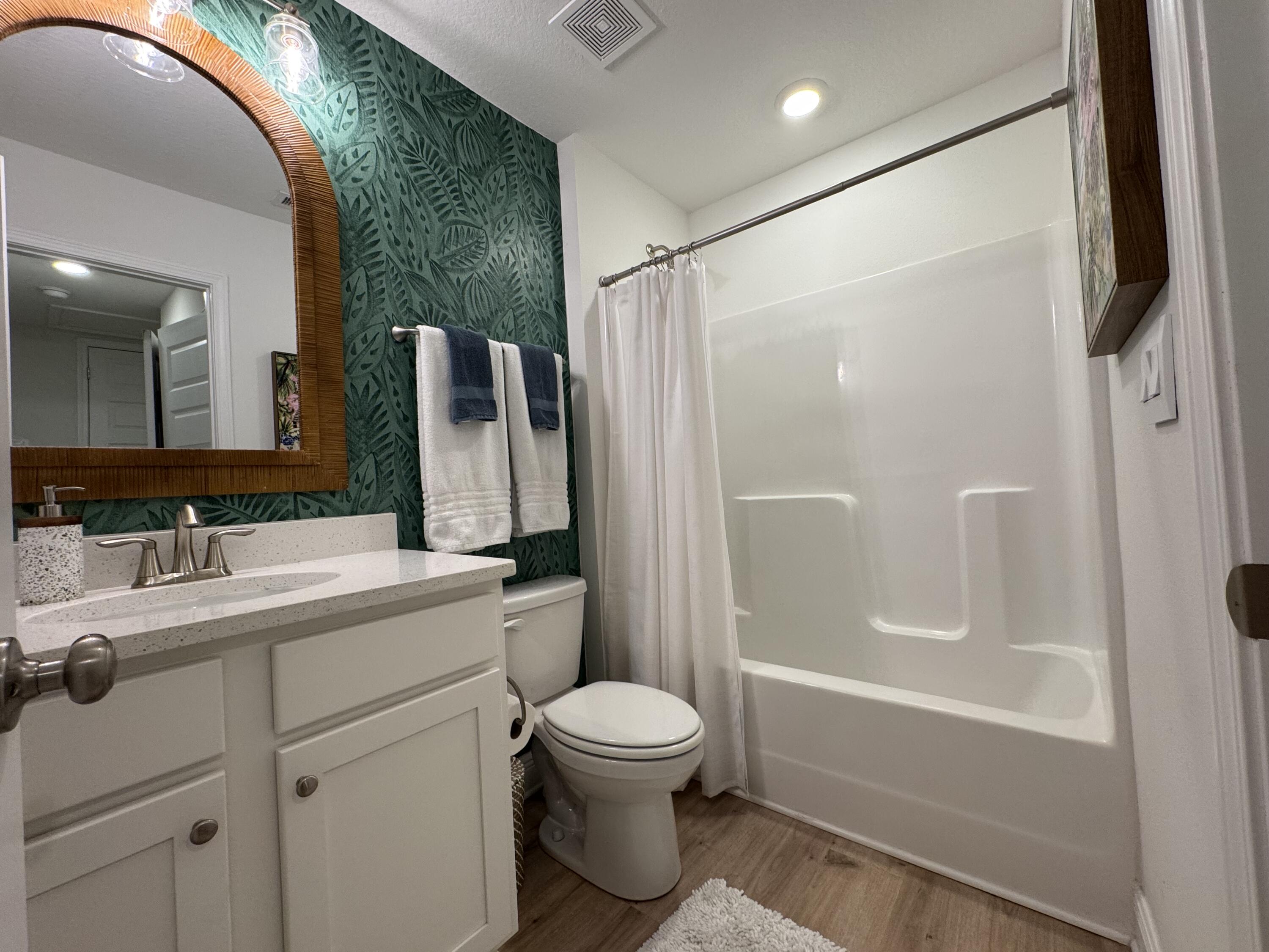 40 Redbird Loop Destin, FL 32541 - Photo 10 of 14 a bathroom with a granite countertop sink toilet and shower